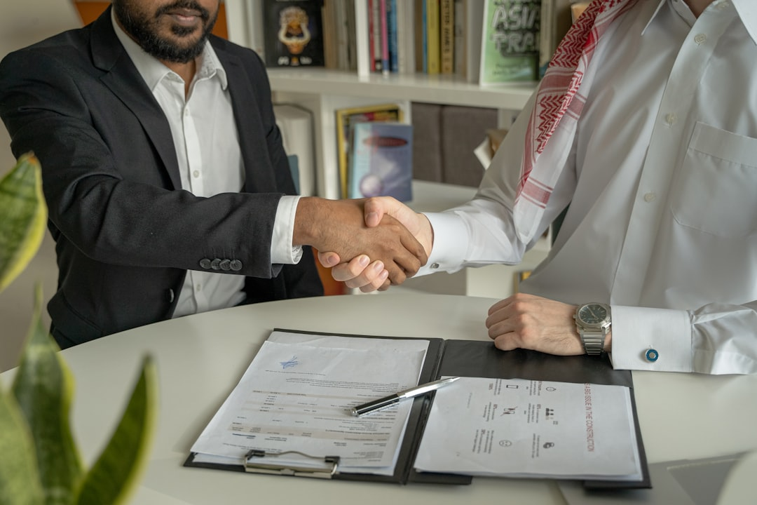 business meeting handshake signing contract
