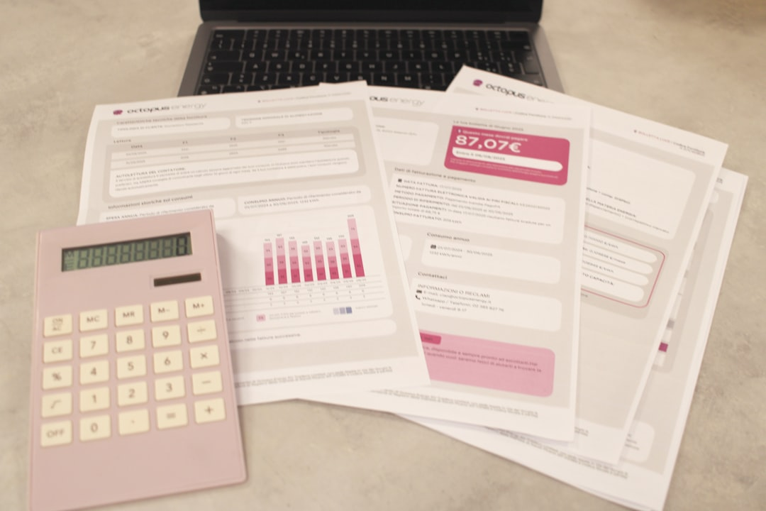 financial documents on desk calculator pen