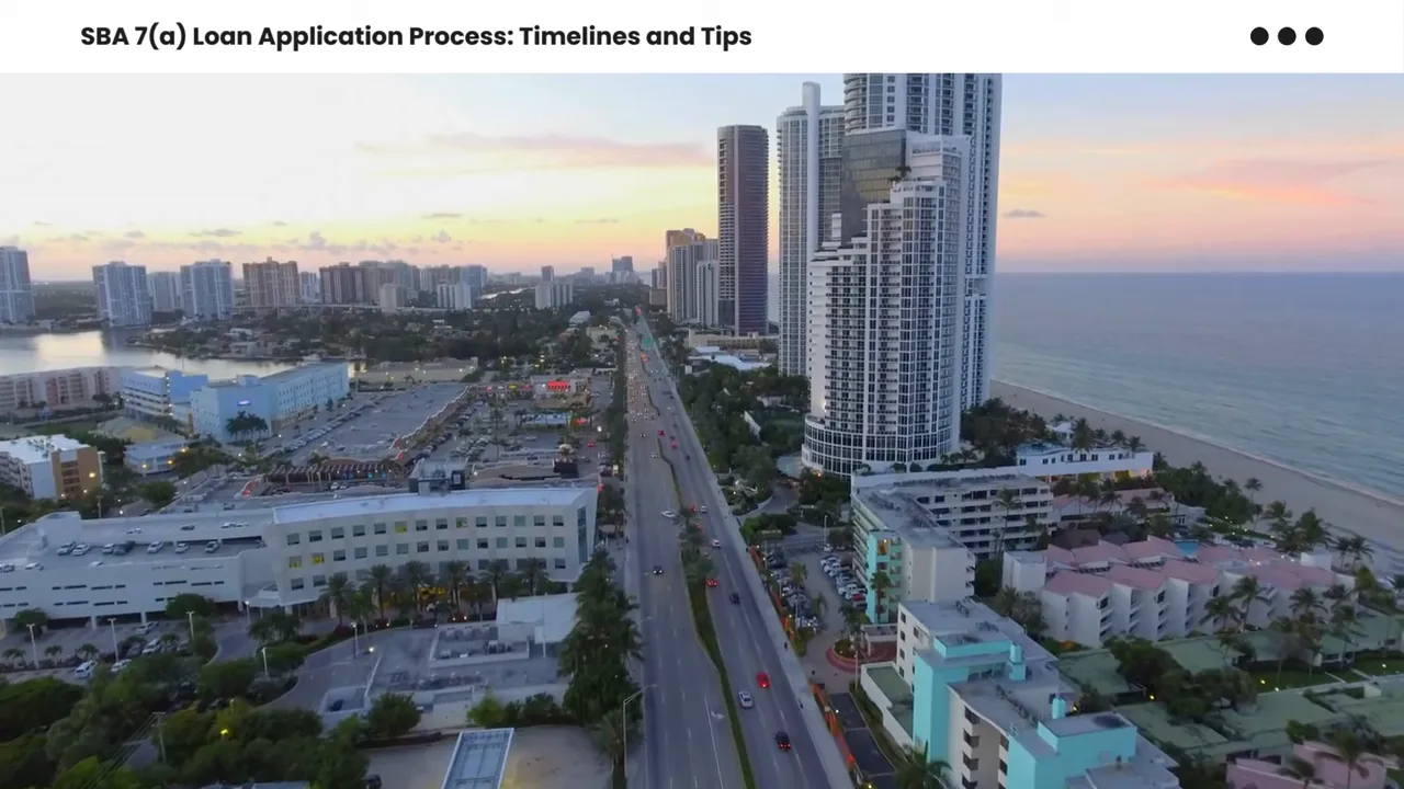Aerial view of a coastal city road and high-rise buildings at sunset, showing commercial properties and development.
