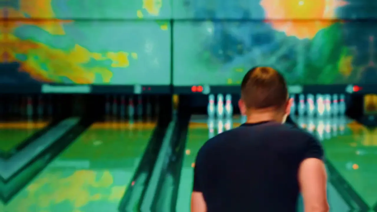 bowling alley lanes with pins visible and a person seen from behind